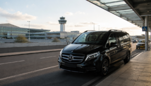Airport transfer in Paris with luxury vehicle outside Charles de Gaulle Airport.